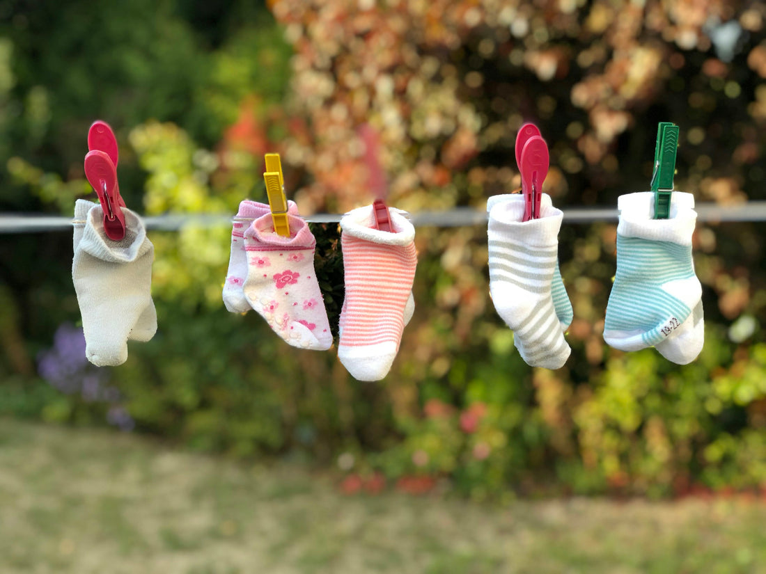 Realistic editorial lifestyle scene showing sock laundry bags in active household use, practical uncluttered setting