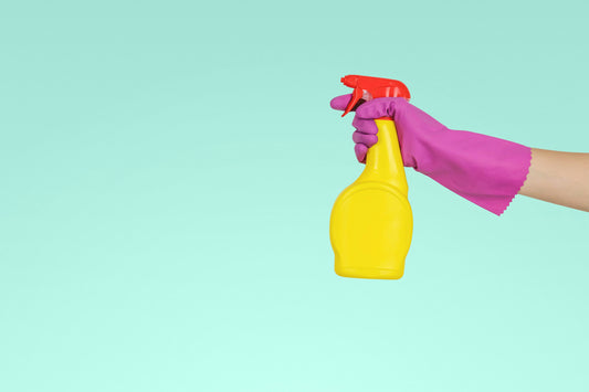 Realistic editorial lifestyle scene showing enzyme cleaner vs all purpose cleaner in active household use, practical unc