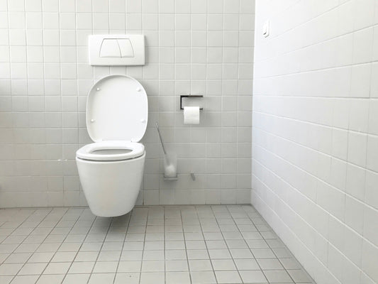 Realistic editorial lifestyle scene showing toilet bowl cleaner gel tablet liquid in active household use, practical unc