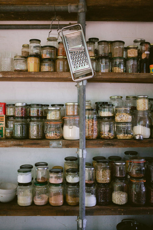 Realistic editorial lifestyle scene showing airtight vs snap lid pantry containers in active household use, practical un
