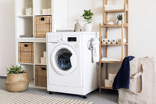 Realistic editorial lifestyle scene showing dryer balls vs dryer sheets in active household use, practical uncluttered s