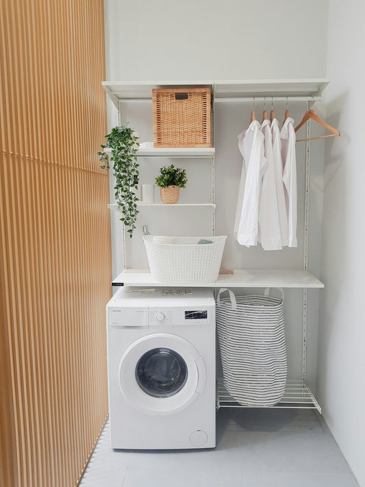 Realistic editorial lifestyle scene showing washing machine descaler in active household use, practical uncluttered sett