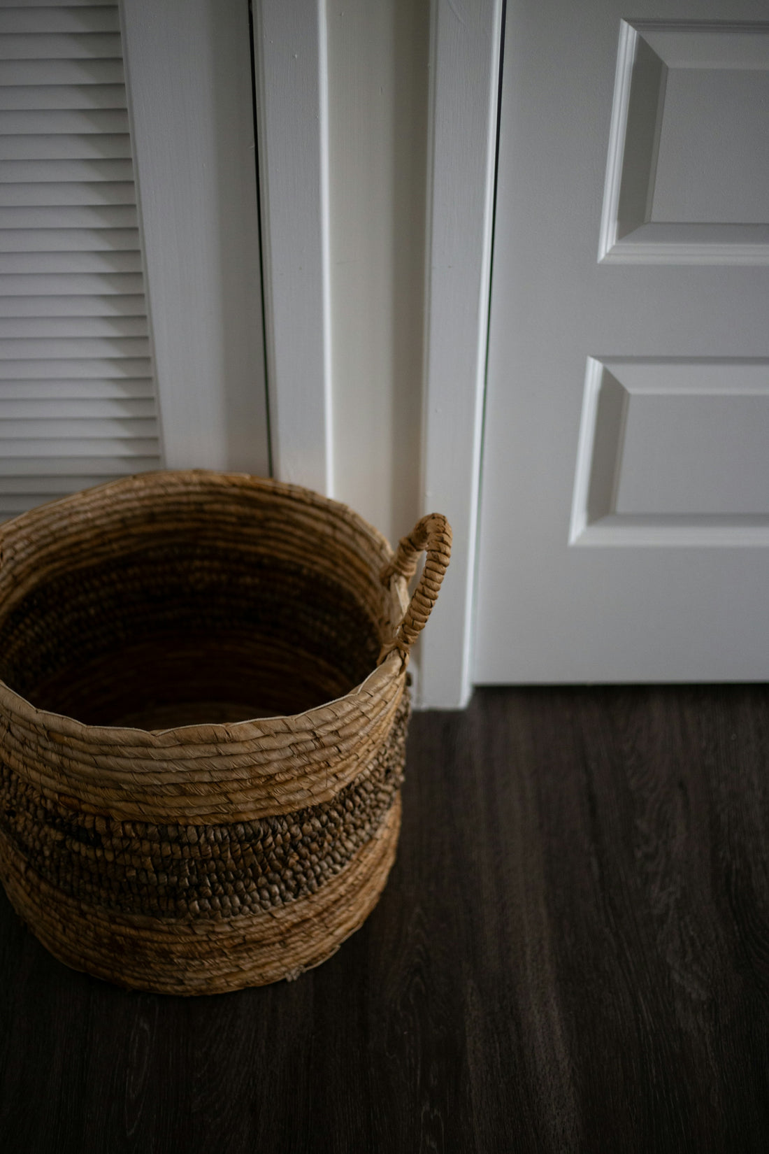 A round woven wicker basket in a home interior