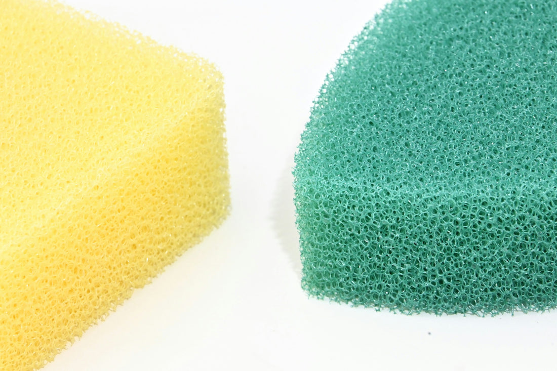 Close-up of yellow and green cleaning sponges