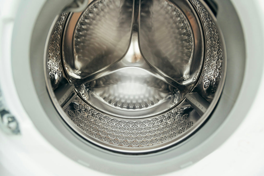 Empty washing machine drum interior for laundry pods vs liquid detergent article